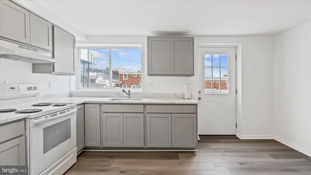 a kitchen with stainless steel appliances granite countertop a sink stove and cabinets