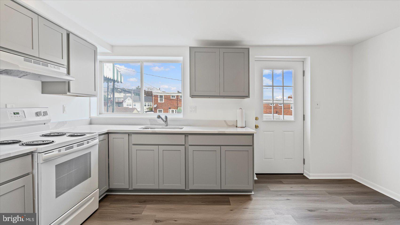 1408 Locust Street Curtis Bay, MD 21226 - Photo 11 of 35 a kitchen with stainless steel appliances granite countertop a sink stove and cabinets