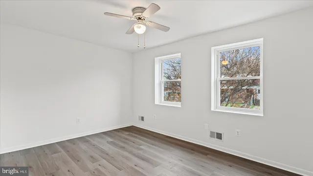wooden floor in an empty room with a window