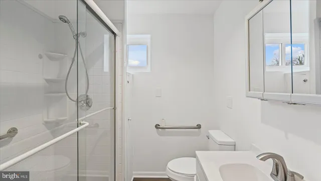 a bathroom with a toilet and a shower
