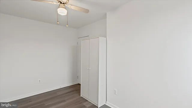 an empty room with a chandelier fan