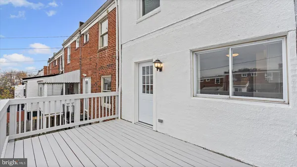 a view of a house with wooden deck