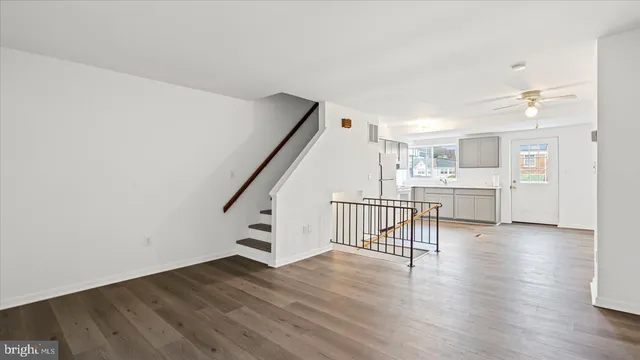 a view of a kitchen with wooden floor and electronic appliances