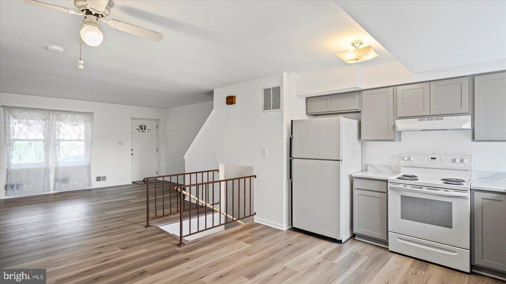1408 Locust Street Curtis Bay, MD 21226 - Photo 10 of 35 a kitchen with white cabinets and white appliances