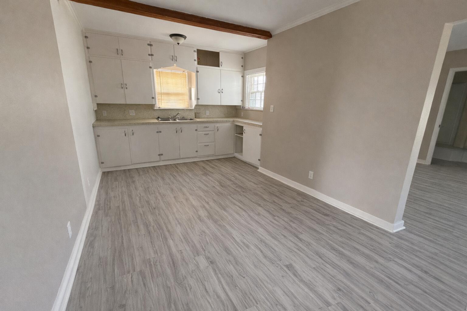 2410 Fisher Street Plainview, TX 79072 - Photo 3 of 8 a view of a kitchen with wooden floor and a sink