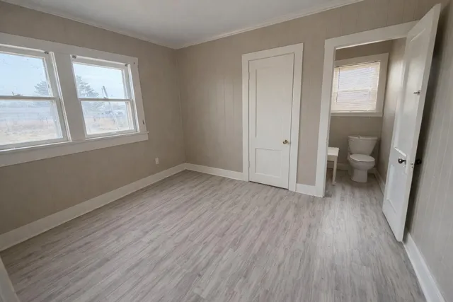 a view of a room with wooden floor and a window