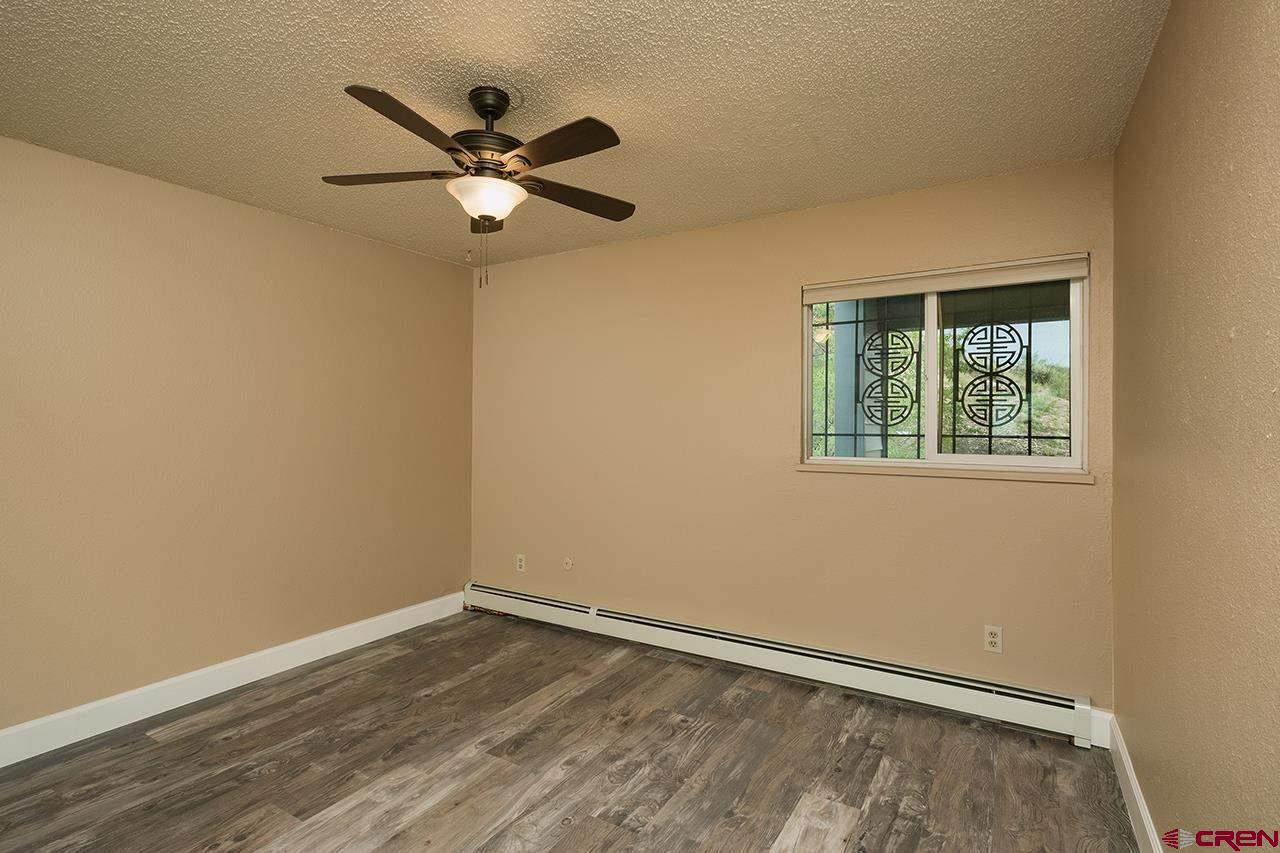 1135 Florida Road, Unit C23 Durango, CO 81301 - Photo 2 of 18 wooden floor in an empty room with a window