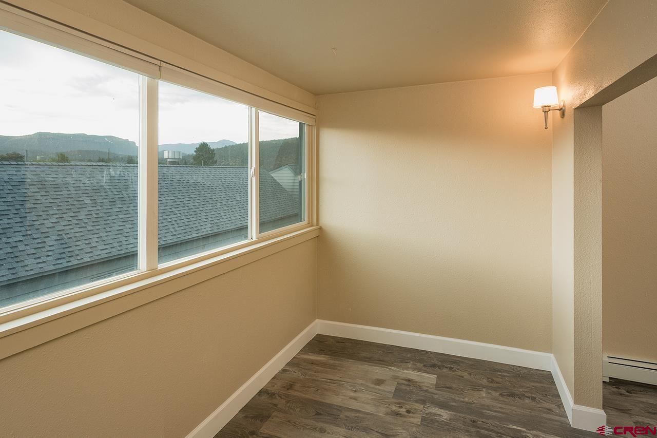 1135 Florida Road, Unit C23 Durango, CO 81301 - Photo 12 of 18 a view of empty room with wooden floor and fan