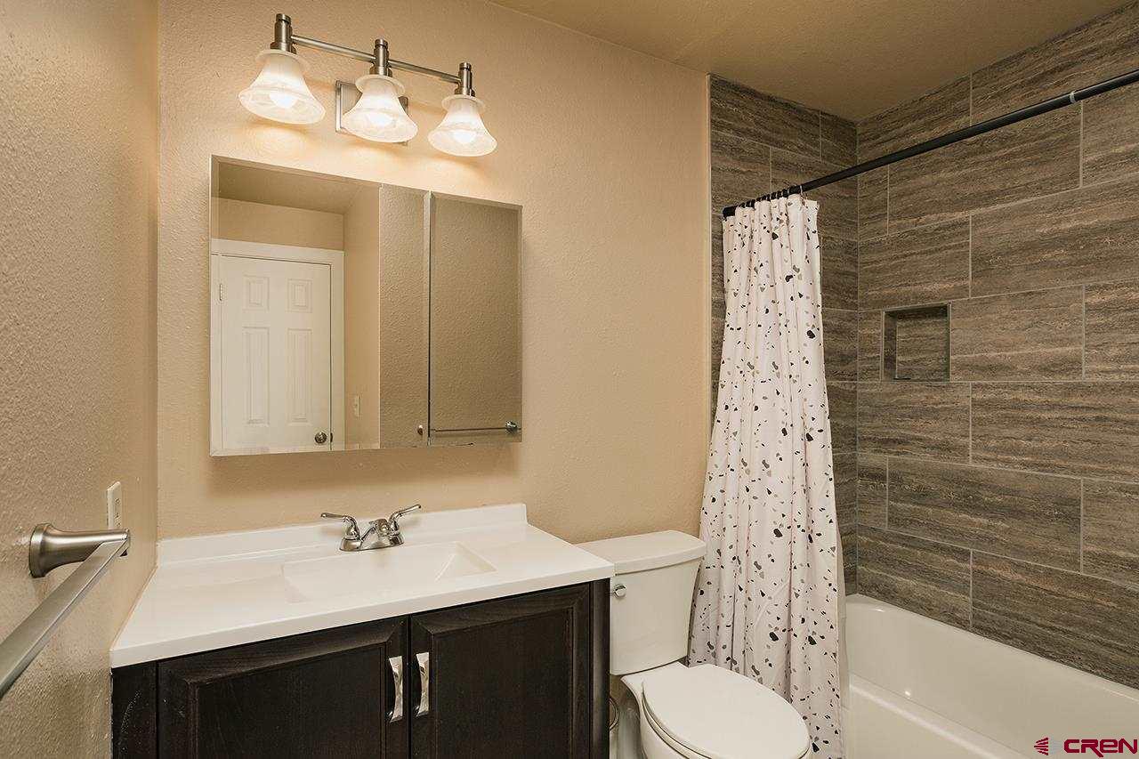 1135 Florida Road, Unit C23 Durango, CO 81301 - Photo 4 of 18 a bathroom with a sink vanity granite toilet tub and shower