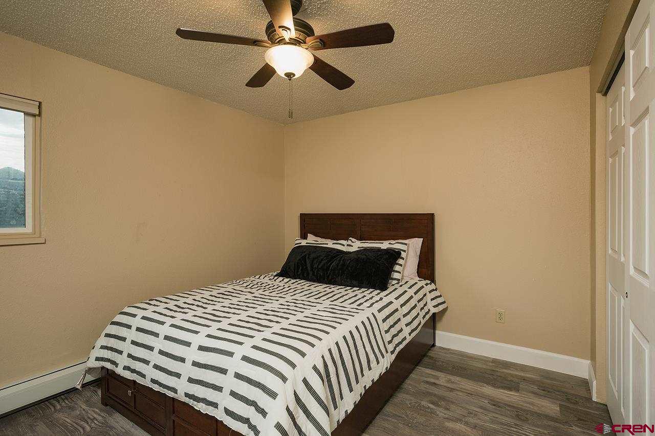 1135 Florida Road, Unit C23 Durango, CO 81301 - Photo 6 of 18 a bedroom with a bed and a ceiling fan
