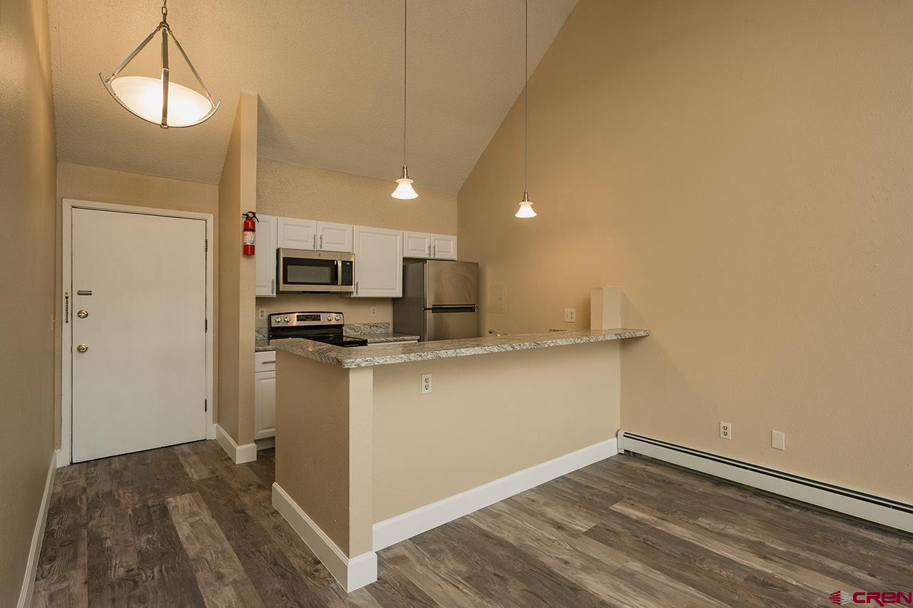 1135 Florida Road, Unit C23 Durango, CO 81301 - Photo 8 of 18 a kitchen with a refrigerator and a stove top oven