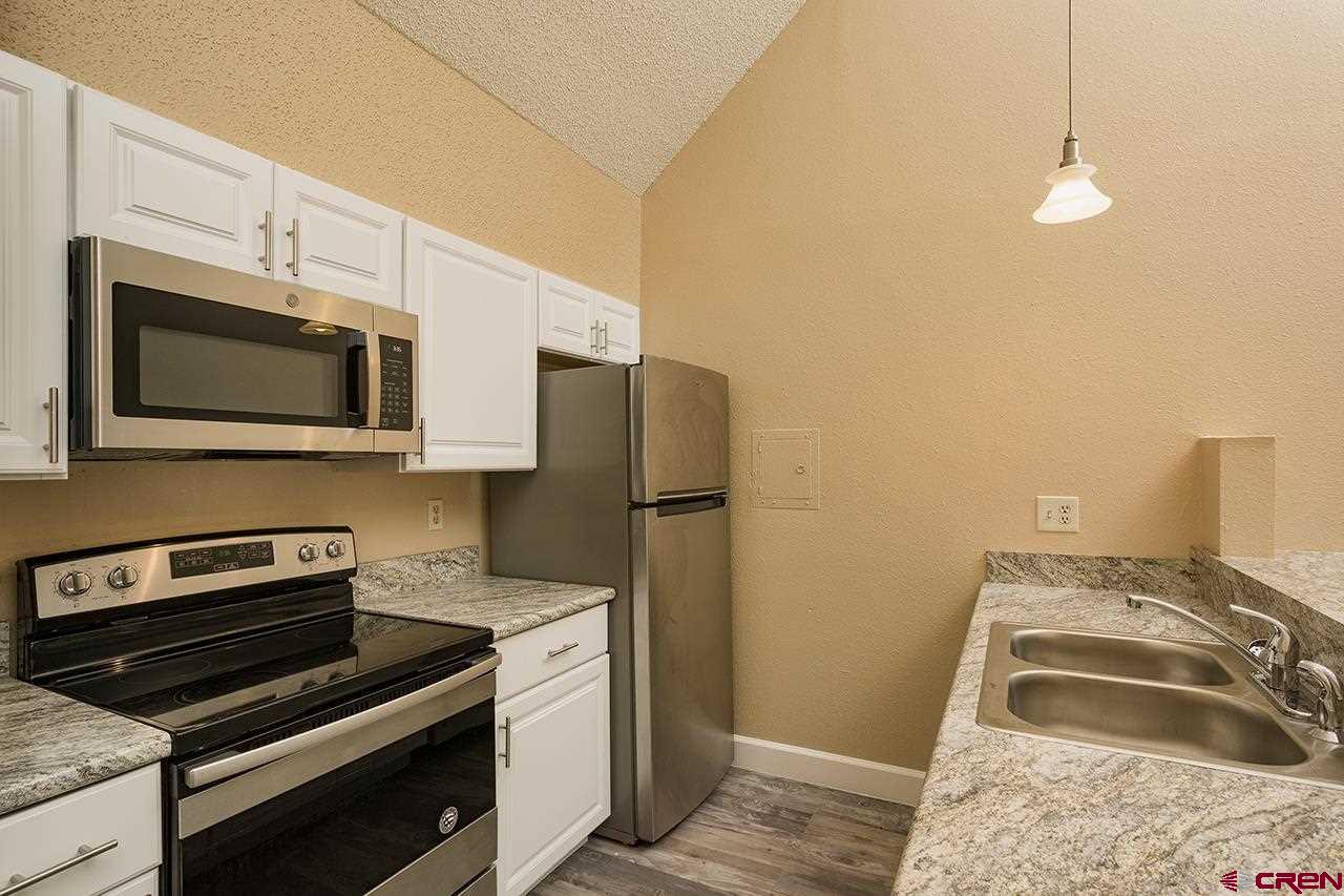 1135 Florida Road, Unit C23 Durango, CO 81301 - Photo 9 of 18 a kitchen with a stove and a microwave