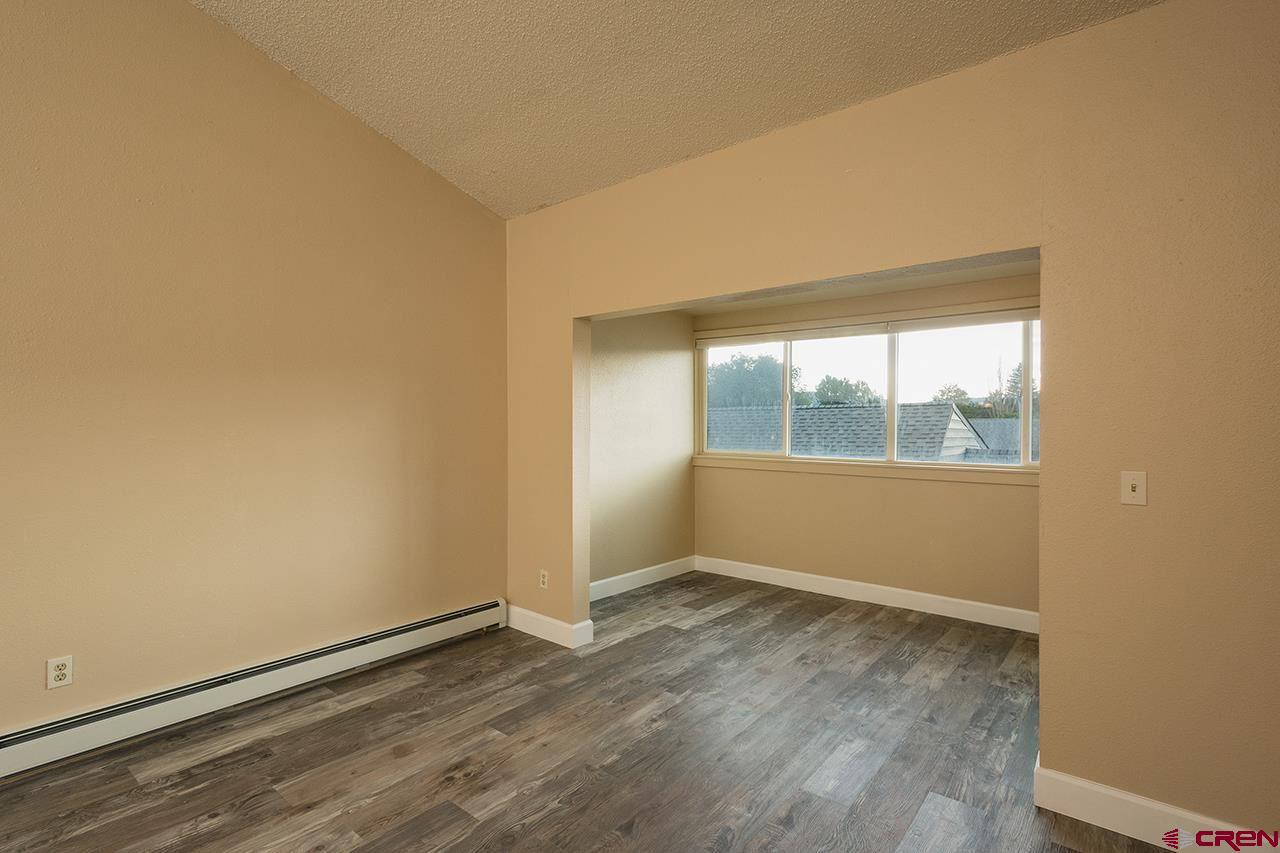 1135 Florida Road, Unit C23 Durango, CO 81301 - Photo 10 of 18 an empty room with wooden floor and windows