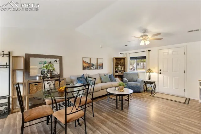 a living room with furniture and wooden floor