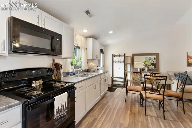 a kitchen with stainless steel appliances a stove microwave and cabinets