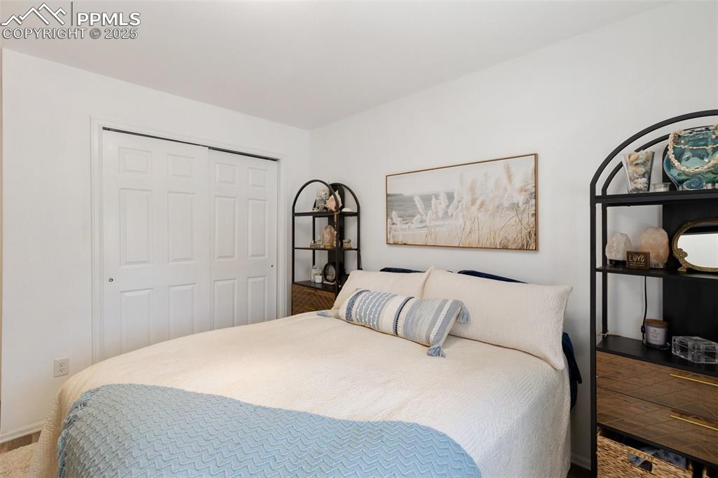 303 East 7th Street Florence, CO 81226 - Photo 24 of 39 a bedroom with a large bed and a painting on the wall