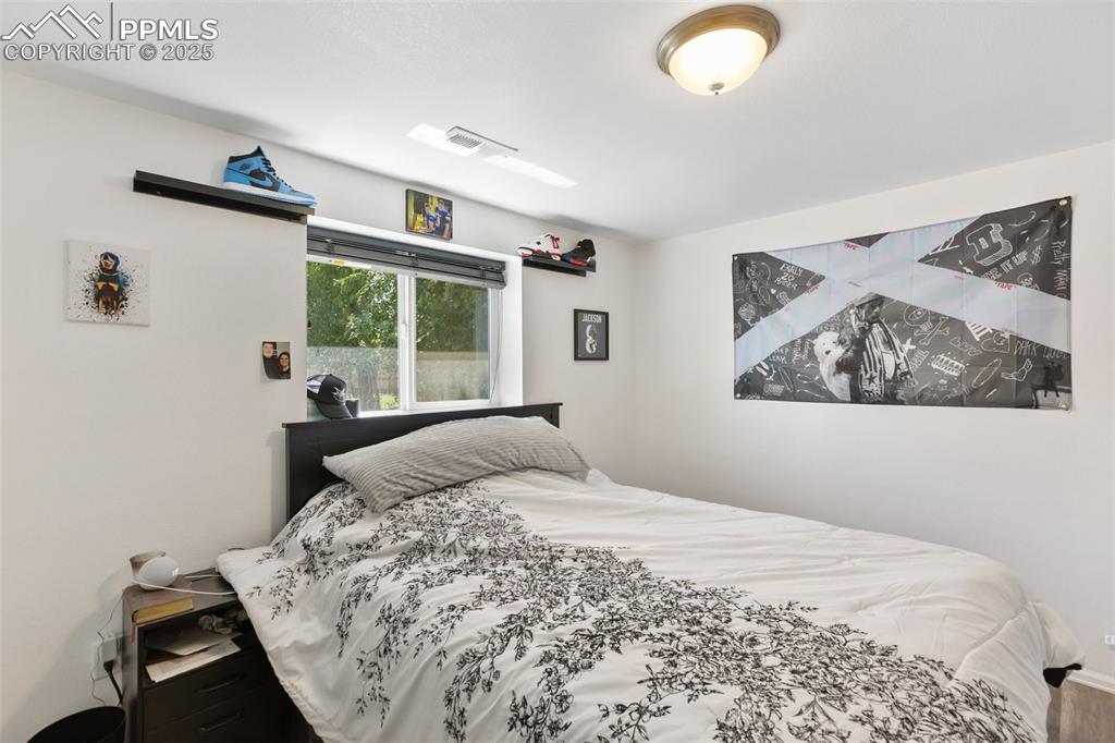 303 East 7th Street Florence, CO 81226 - Photo 30 of 39 a bedroom with a bed and a large window