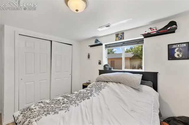 a bedroom with a bed and a window