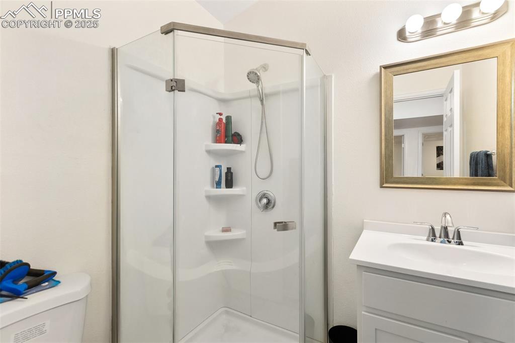 303 East 7th Street Florence, CO 81226 - Photo 33 of 39 a bathroom with a shower sink and a mirror