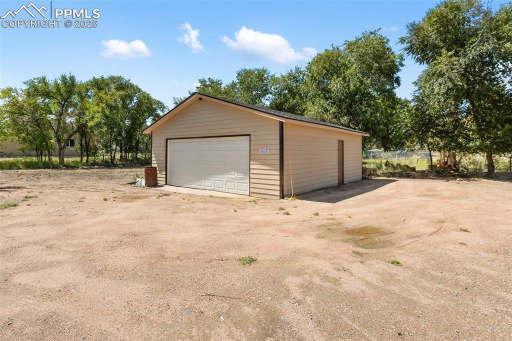 303 East 7th Street Florence, CO 81226 - Photo 4 of 39 a view of garage yard and tree