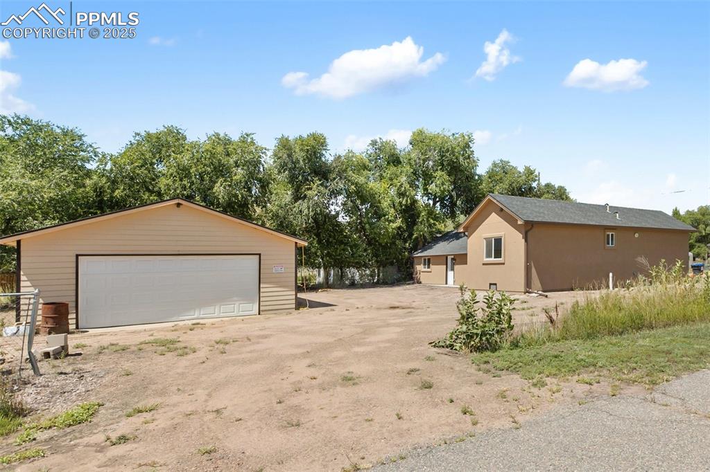 303 East 7th Street Florence, CO 81226 - Photo 5 of 39 a front view of a house with a yard and garage