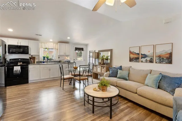 a living room with furniture and a wooden floor