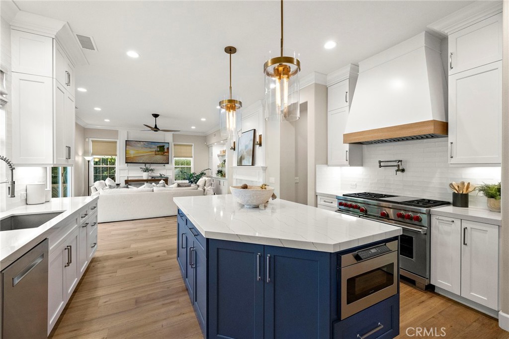 16 Wyndham Street Ladera Ranch, CA 92694 - Photo 11 of 58 a kitchen with a sink stove and wooden cabinets