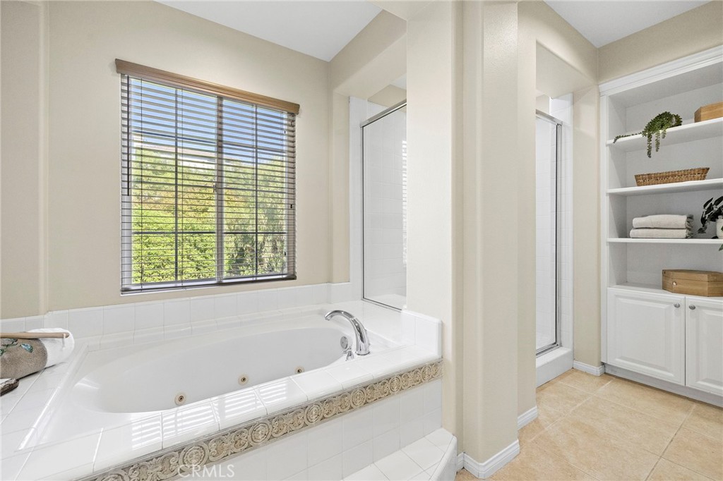 16 Wyndham Street Ladera Ranch, CA 92694 - Photo 27 of 58 a white bath tub sitting in a bathroom next to a window