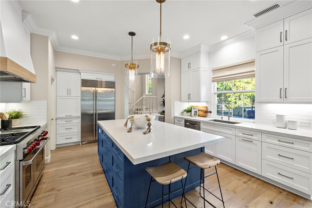 16 Wyndham Street Ladera Ranch, CA 92694 - Photo 10 of 58 a kitchen with a sink stove and wooden cabinets