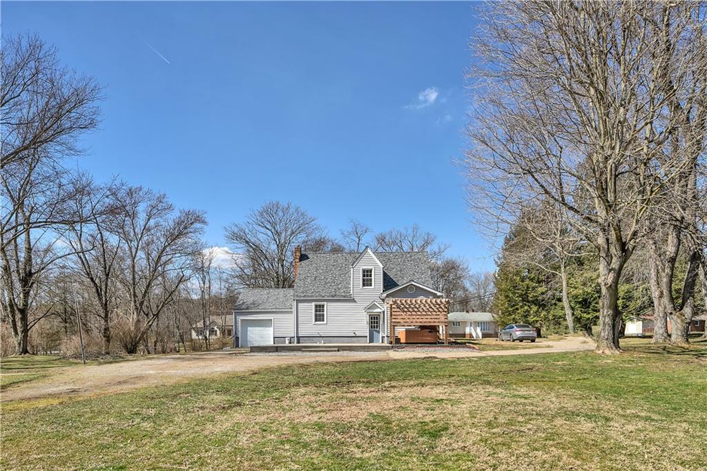 95 Mary Reed Road Baden, PA 15005 - Photo 23 of 25 a front view of a house with a yard and a large tree
