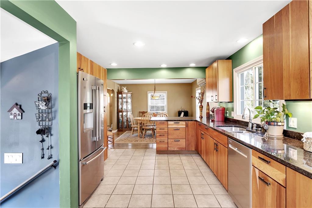 95 Mary Reed Road Baden, PA 15005 - Photo 10 of 25 a large kitchen with stainless steel appliances a sink and cabinets