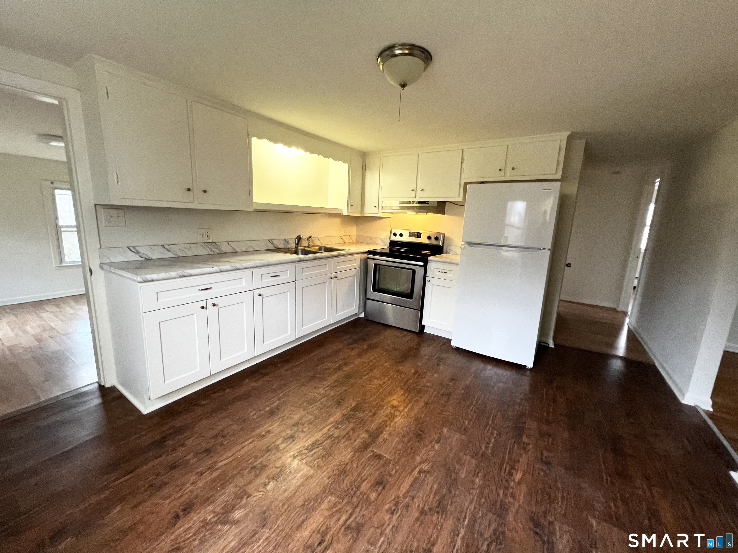 565 East Main Street, Unit 6 Middletown, CT 06457 - Photo 1 of 1 a kitchen with a sink a refrigerator and white cabinets