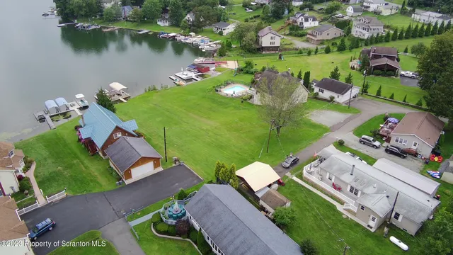 an aerial view of a house with yard swimming pool and outdoor seating