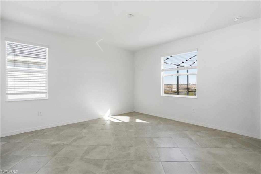 3958 Button Sage Road Alva, FL 33920 - Photo 14 of 50 an empty room with windows
