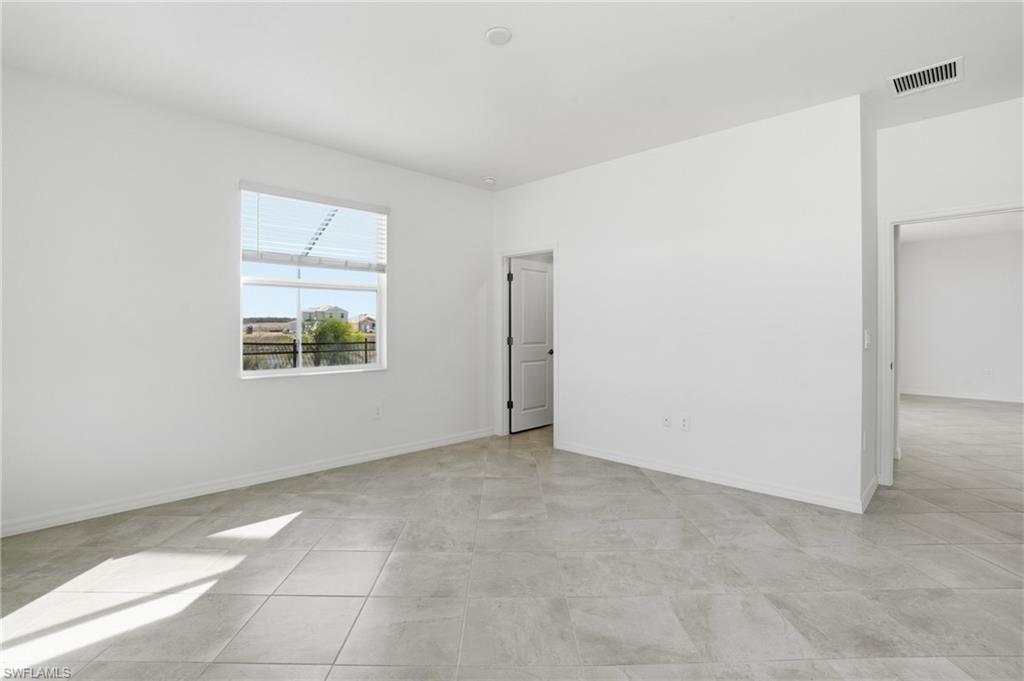 3958 Button Sage Road Alva, FL 33920 - Photo 15 of 50 an empty room with windows