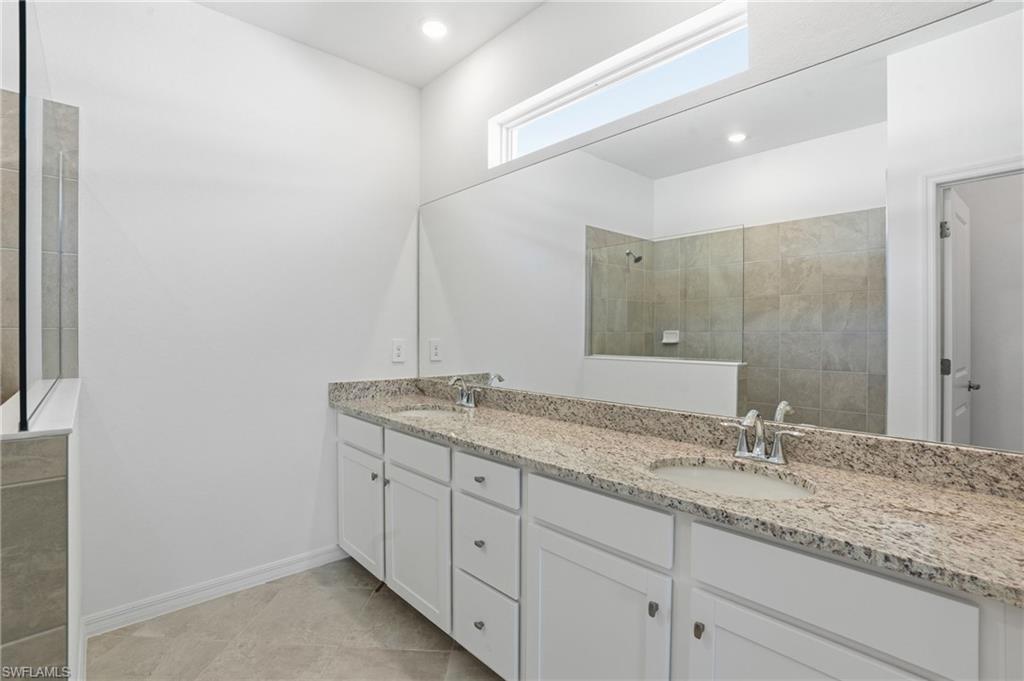 3958 Button Sage Road Alva, FL 33920 - Photo 17 of 50 a bathroom with a granite countertop sink double and mirror