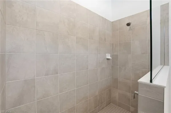 a bathroom with a granite countertop sink double and mirror