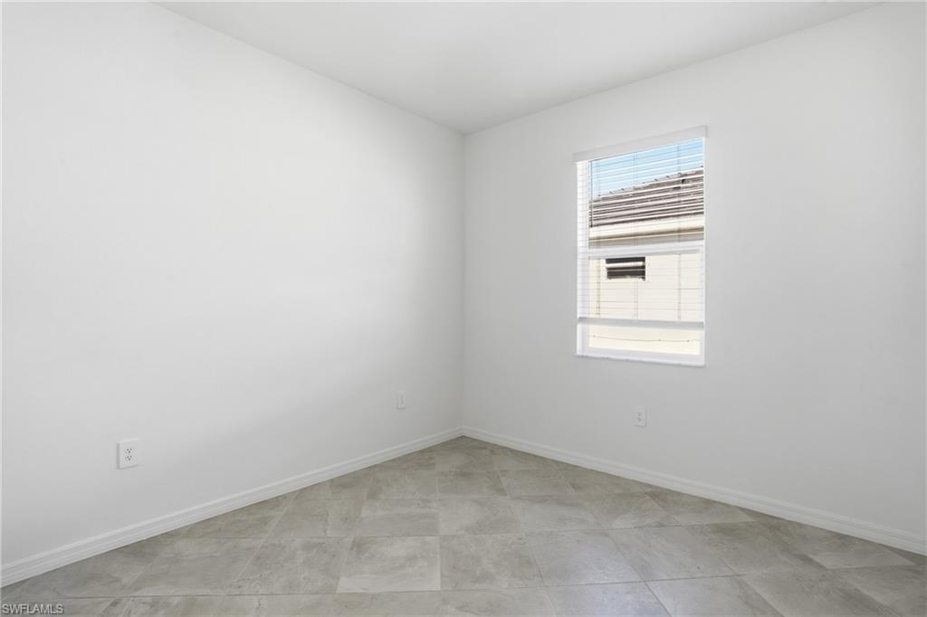 3958 Button Sage Road Alva, FL 33920 - Photo 21 of 50 an empty room with a window