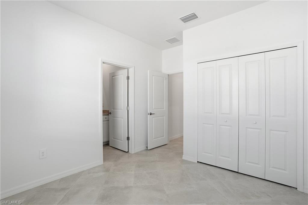 3958 Button Sage Road Alva, FL 33920 - Photo 22 of 50 a view of a closet area with an empty room