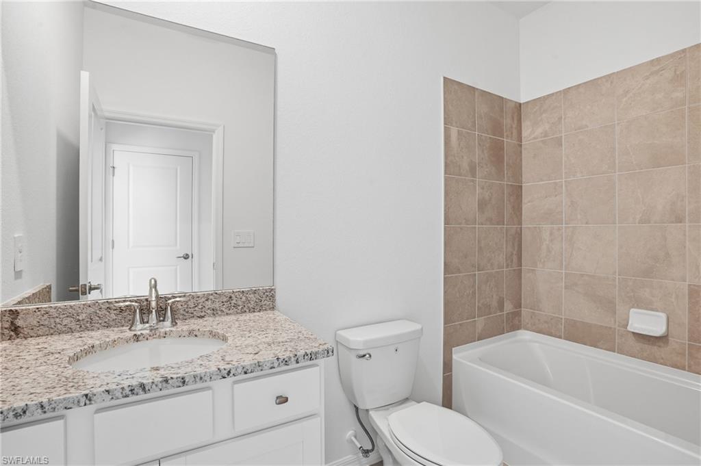 3958 Button Sage Road Alva, FL 33920 - Photo 26 of 50 a bathroom with a granite countertop sink toilet and shower