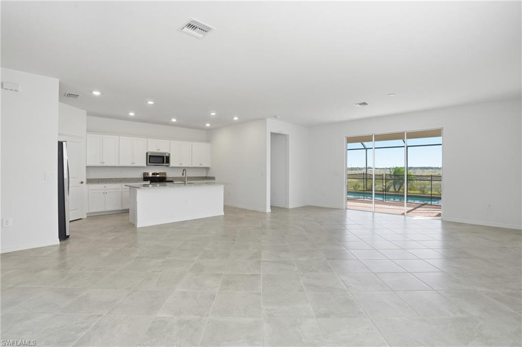 3958 Button Sage Road Alva, FL 33920 - Photo 7 of 50 a view of kitchen with stainless steel appliances refrigerator oven and cabinets