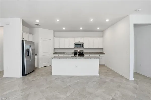 a kitchen with refrigerator a sink and cabinets