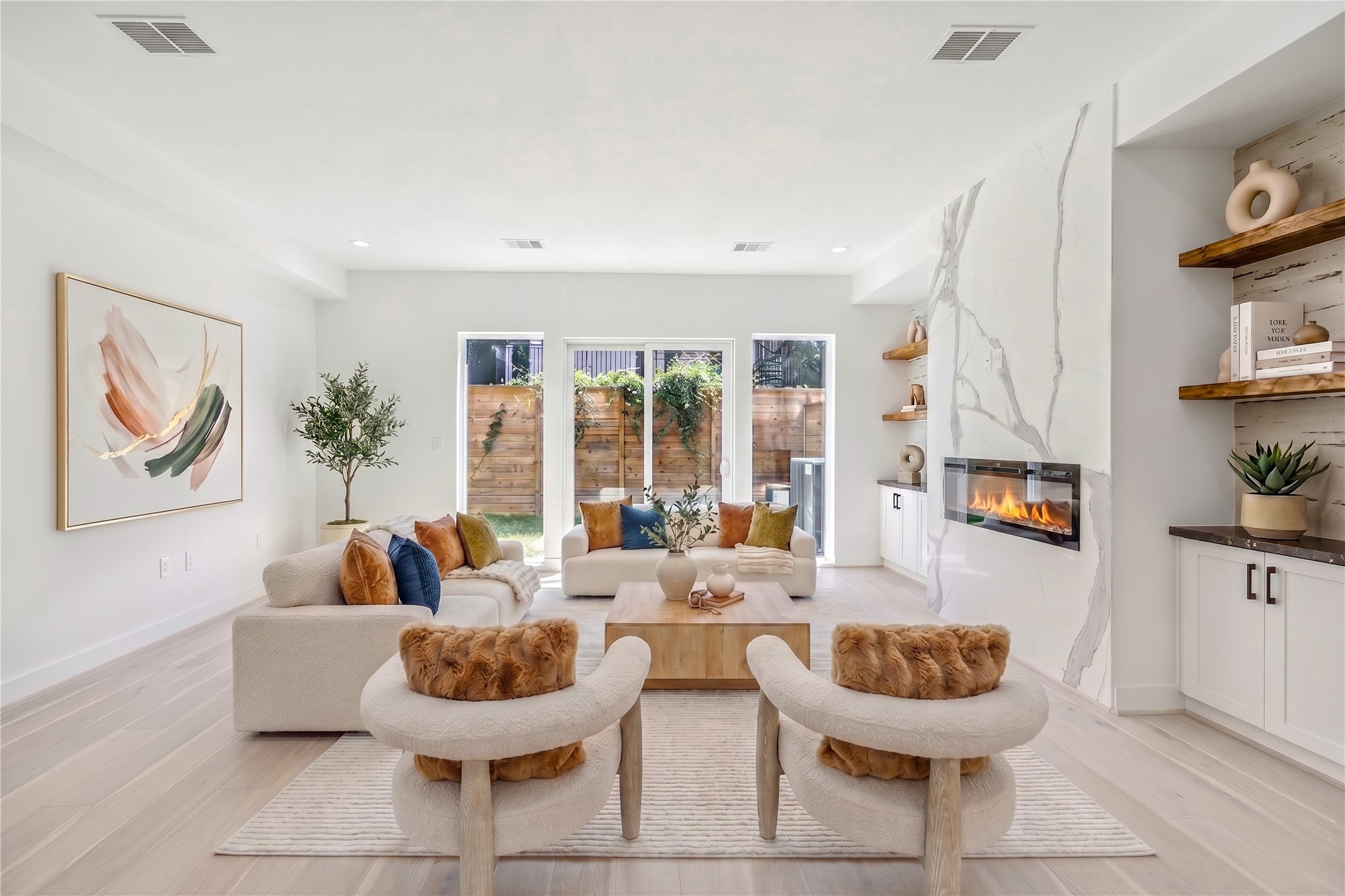 6209 Westcott Street Houston, TX 77007 - Photo 2 of 16 Living Room – Located on the first floor, this inviting space features double French doors opening to the backyard, filling the room with beautiful natural light, along with custom built-ins (virtal staging)