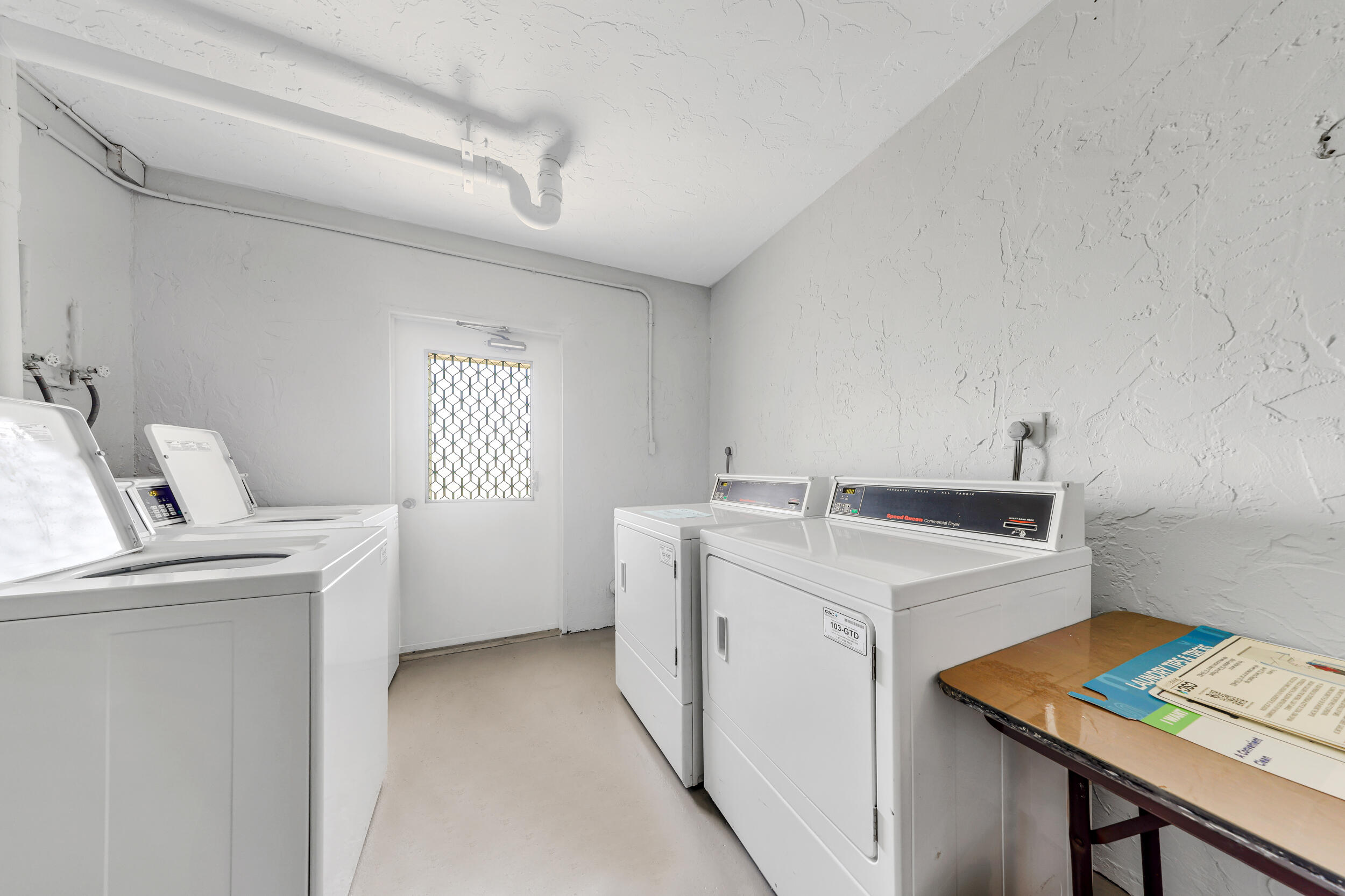 3091 North Course Drive, Unit 102 Pompano Beach, FL 33069 - Photo 16 of 16 a utility room with dryer and washer