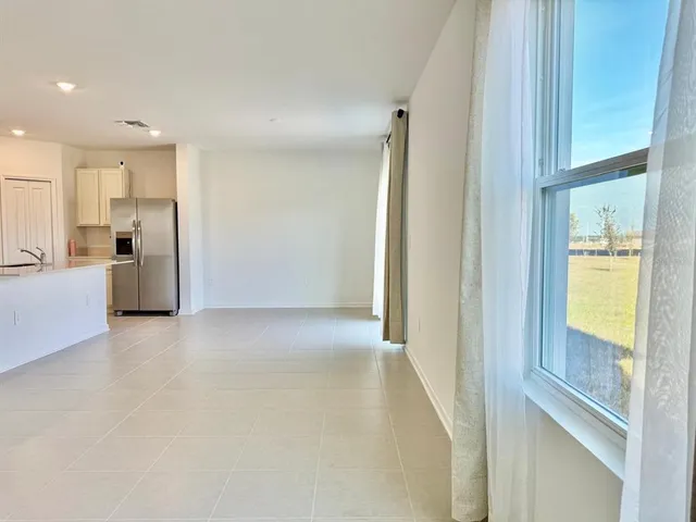 a view of an empty room with glass door