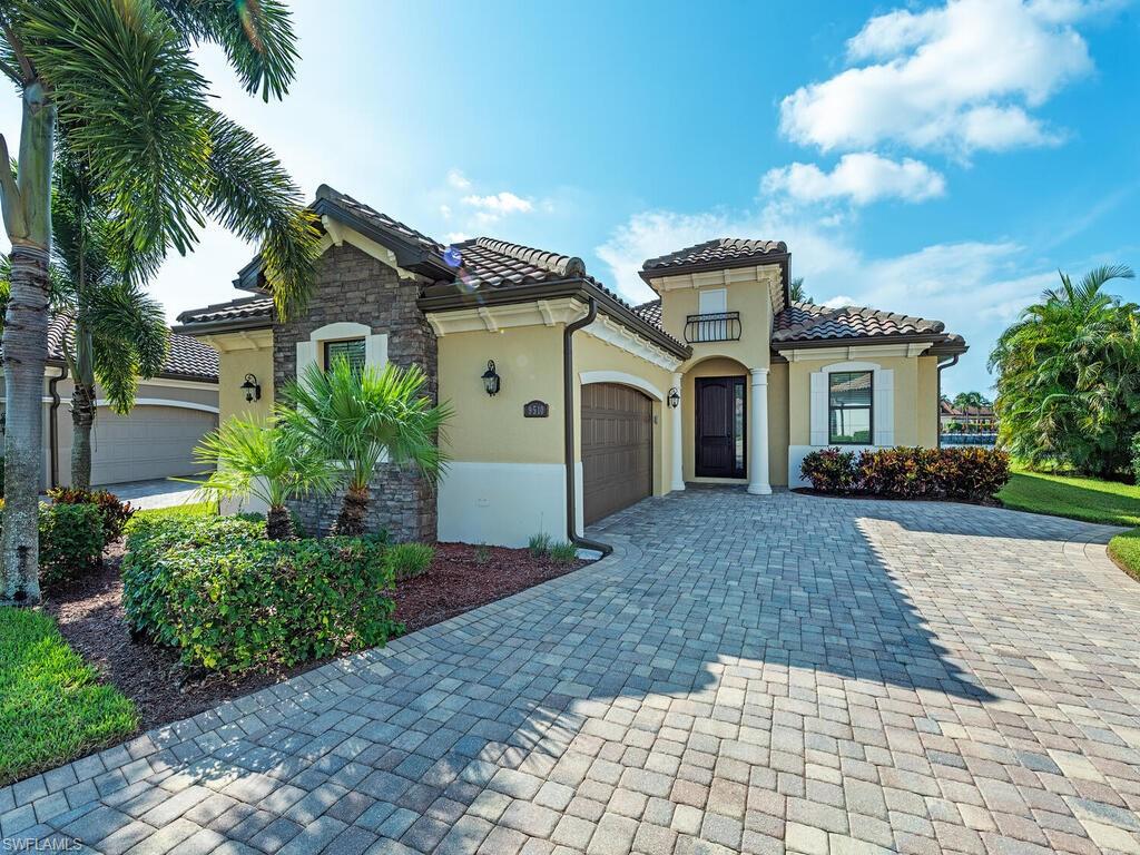 9510 Piacere Way Naples, FL 34113 - Photo 3 of 14 a front view of a house with a yard and a garage