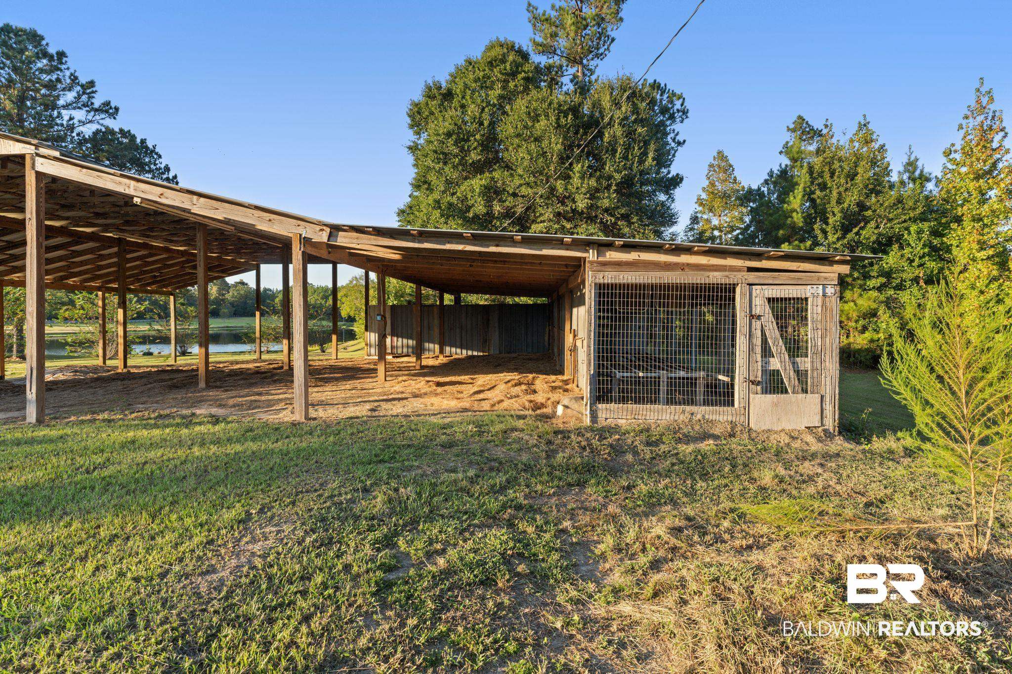 888 Mobile Cut-Off Road St. Stephens, AL 36569 - Photo 36 of 54 Exterior space with an outdoor structure, exterior structure, and a water view