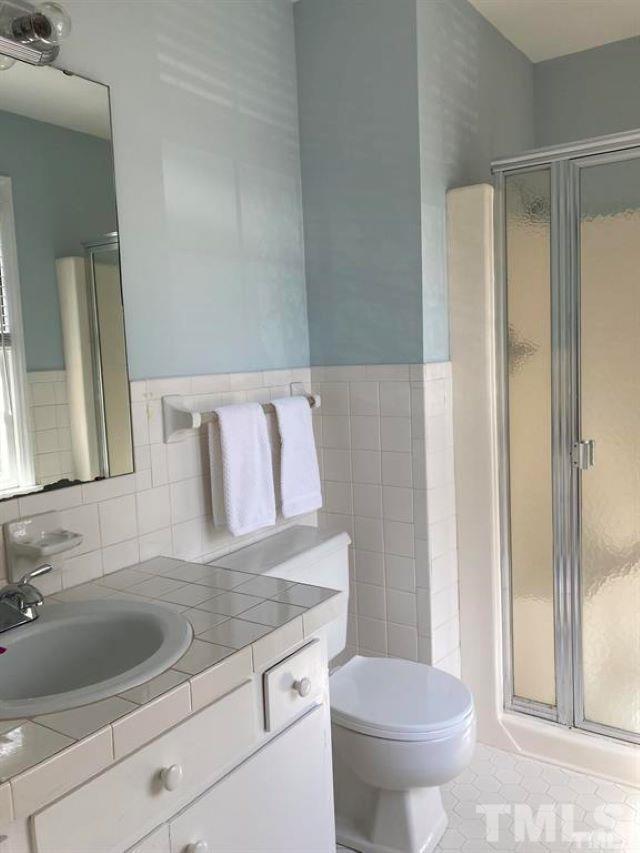 2892 Wycliff Road Raleigh, NC 27607 - Photo 20 of 20 a bathroom with a granite countertop sink a toilet and a mirror