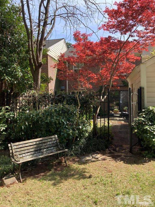 2892 Wycliff Road Raleigh, NC 27607 - Photo 7 of 20 a view of a bench in a yard