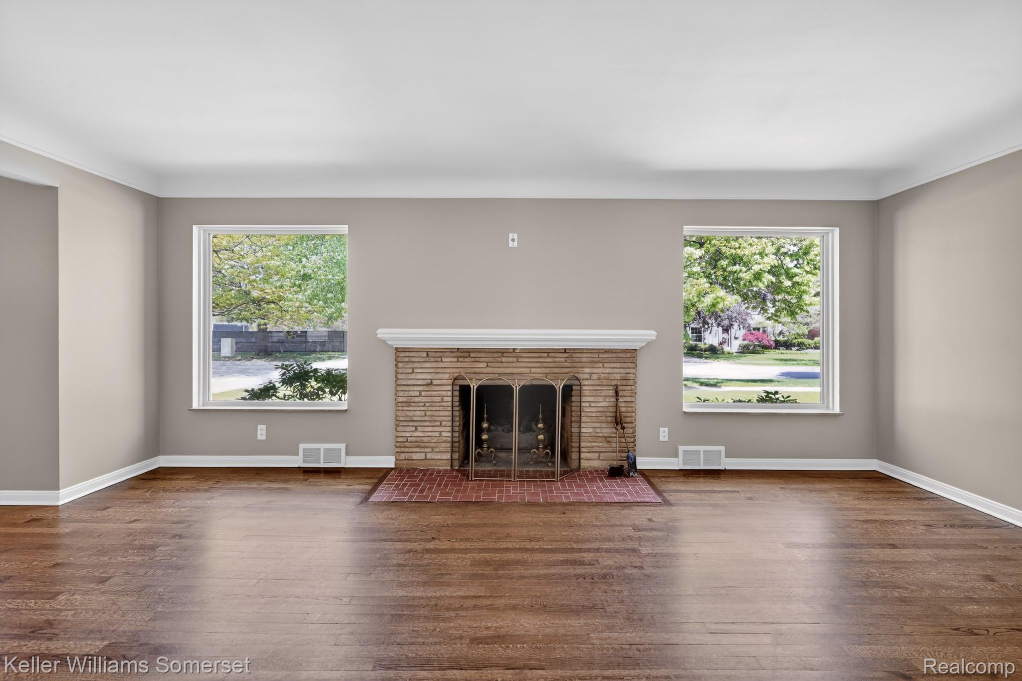 1681 Oxford Road Grosse Pointe, MI 48236 - Photo 5 of 25 Unfurnished living room with a fireplace with flush hearth and dark wood-style flooring